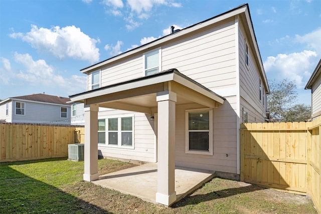 back of property featuring a lawn and a patio