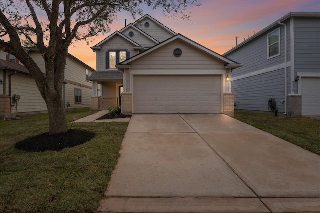 view of front facade with a garage and a yard