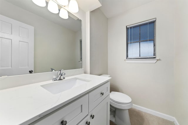 bathroom featuring vanity, tile patterned flooring, and toilet