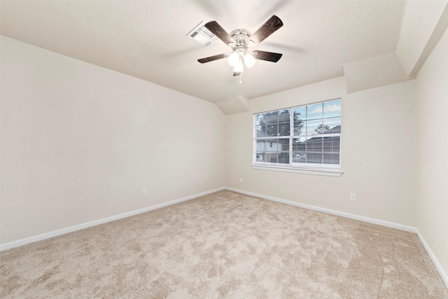 spare room featuring light colored carpet and ceiling fan