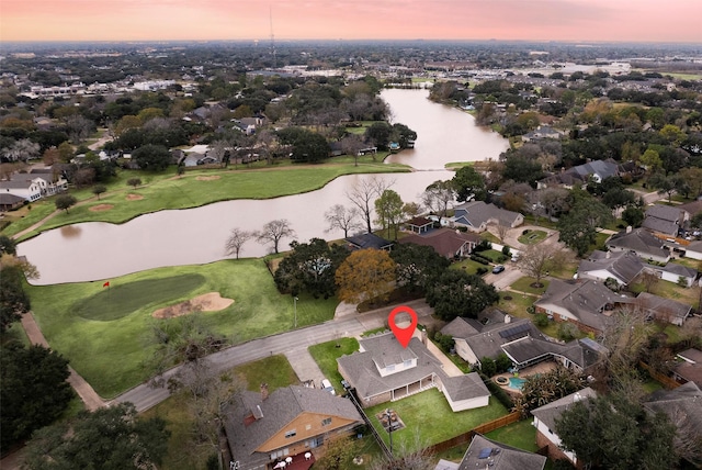 aerial view at dusk with a water view