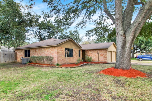 ranch-style home with a front lawn, a garage, and central air condition unit