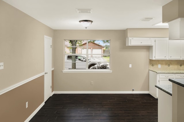 unfurnished dining area with dark hardwood / wood-style flooring