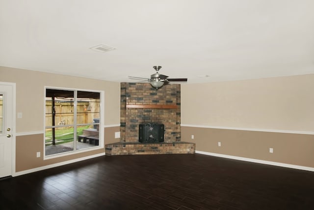 unfurnished living room with ceiling fan, a brick fireplace, and hardwood / wood-style floors