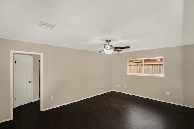 empty room with ceiling fan and dark hardwood / wood-style flooring