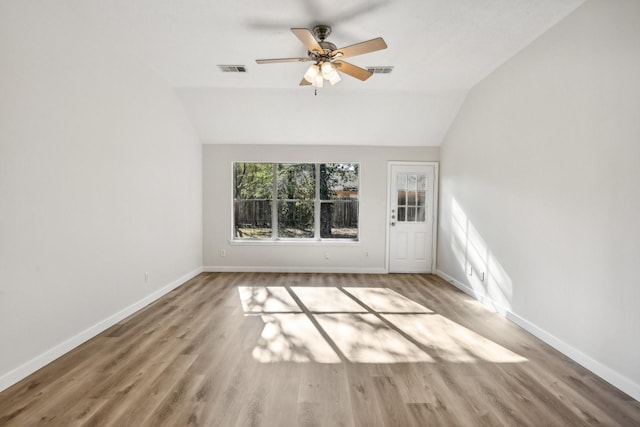 spare room with ceiling fan, vaulted ceiling, and hardwood / wood-style flooring