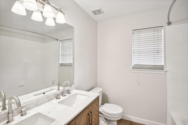 full bathroom featuring toilet, vanity, and shower / bathing tub combination