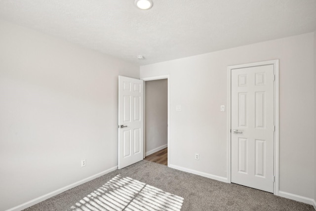 unfurnished bedroom featuring dark carpet