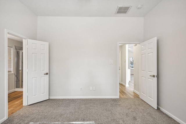 unfurnished bedroom with light colored carpet