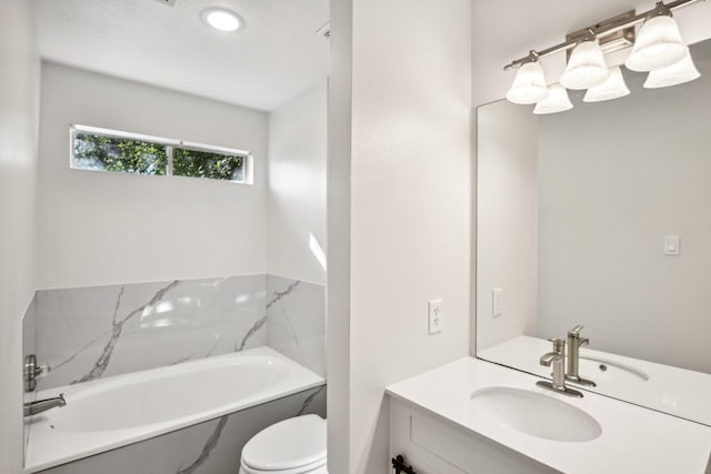 bathroom with toilet, vanity, and a bathtub