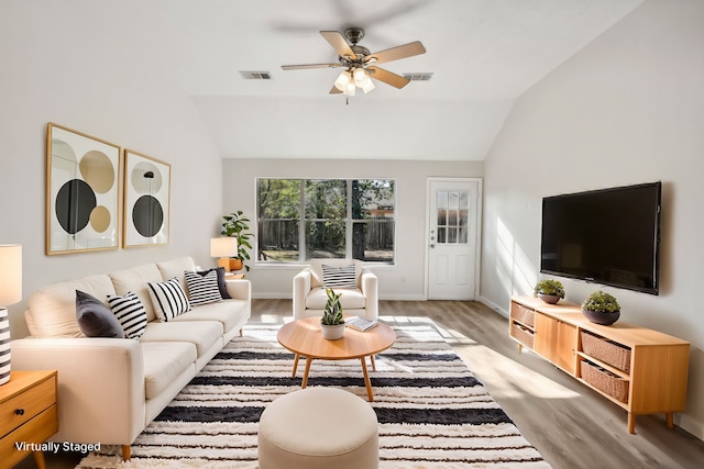 living room with light wood-type flooring, ceiling fan, and lofted ceiling