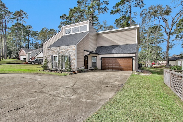 view of front facade with a garage and a front lawn