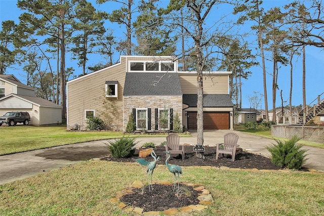 back of property with a garage and a lawn