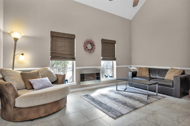 tiled living room featuring a wealth of natural light, high vaulted ceiling, and ceiling fan