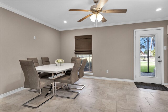 dining space with ornamental molding and ceiling fan