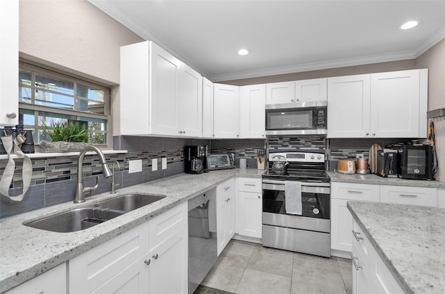 kitchen featuring stainless steel appliances, light tile patterned flooring, sink, and white cabinets