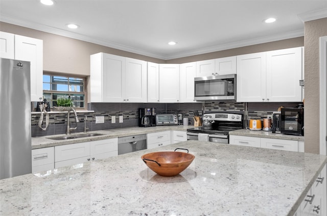 kitchen featuring white cabinetry, sink, light stone countertops, and appliances with stainless steel finishes