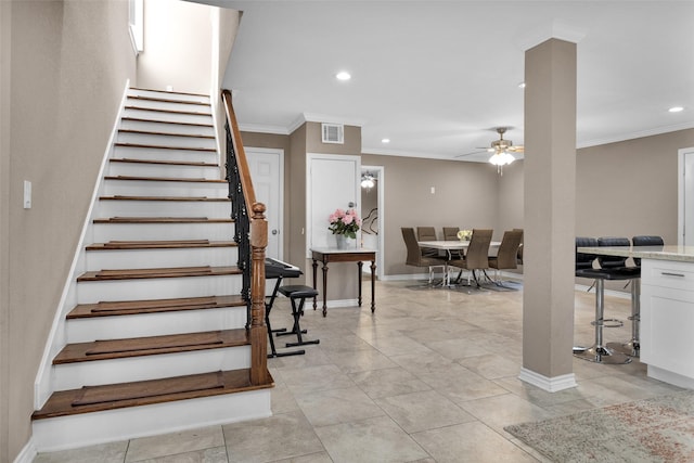 stairway featuring ornamental molding and ceiling fan