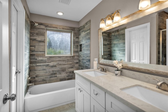 bathroom featuring tiled shower / bath combo, vanity, and tile patterned floors