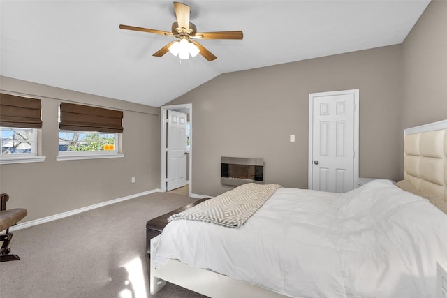 carpeted bedroom with ceiling fan and vaulted ceiling