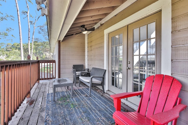 wooden deck featuring ceiling fan and french doors