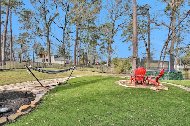 view of yard featuring a trampoline and a playground