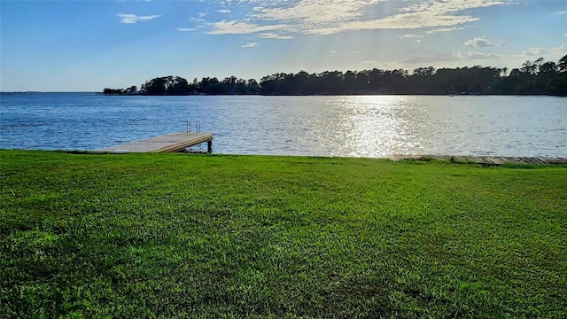 dock area featuring a water view and a yard