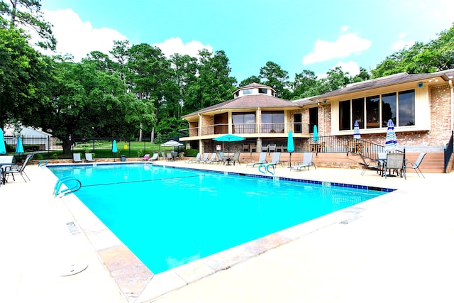 view of swimming pool featuring a patio area