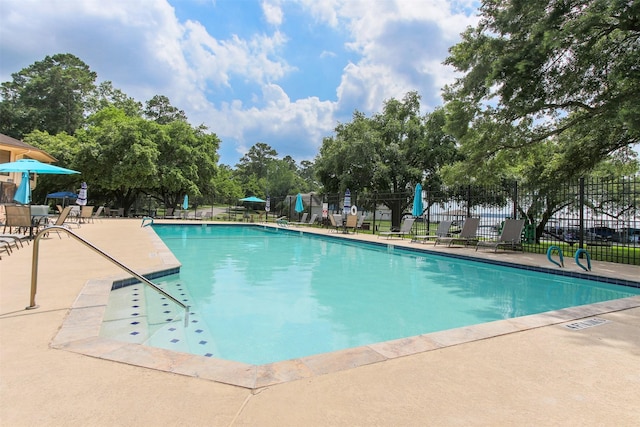 view of swimming pool with a patio