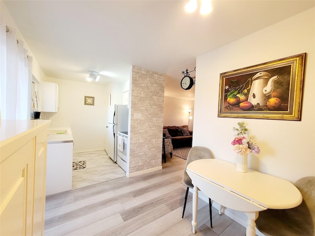 dining area with light hardwood / wood-style floors