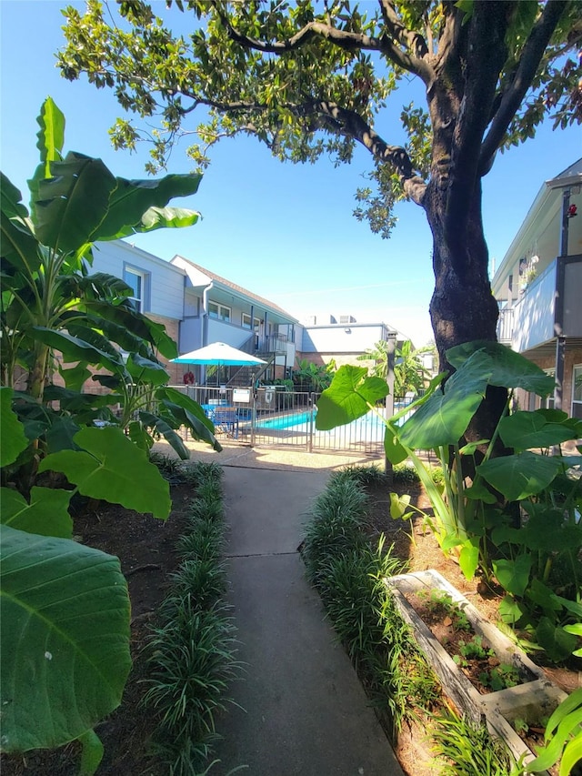 view of property's community featuring a patio area and a swimming pool