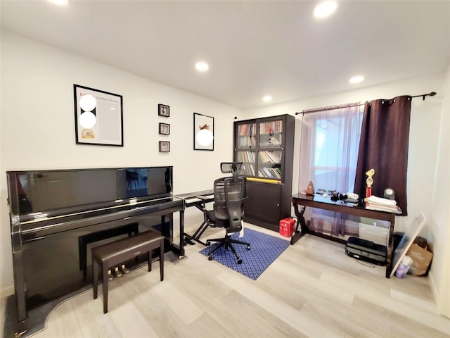 home office with light hardwood / wood-style flooring