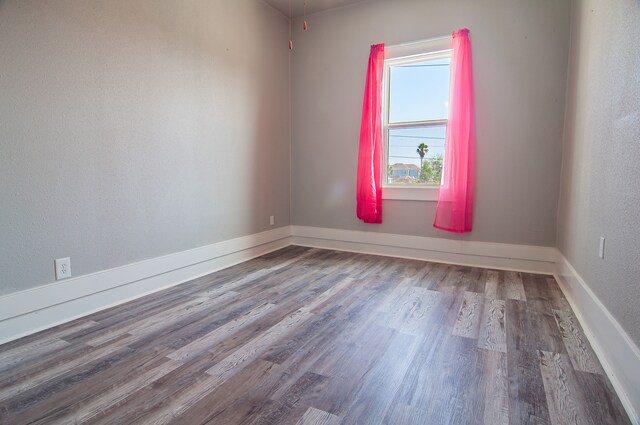 unfurnished room featuring hardwood / wood-style flooring