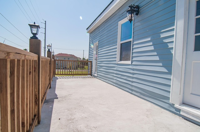 view of patio featuring fence