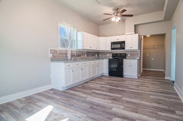 kitchen with tasteful backsplash, black appliances, white cabinets, and light wood finished floors