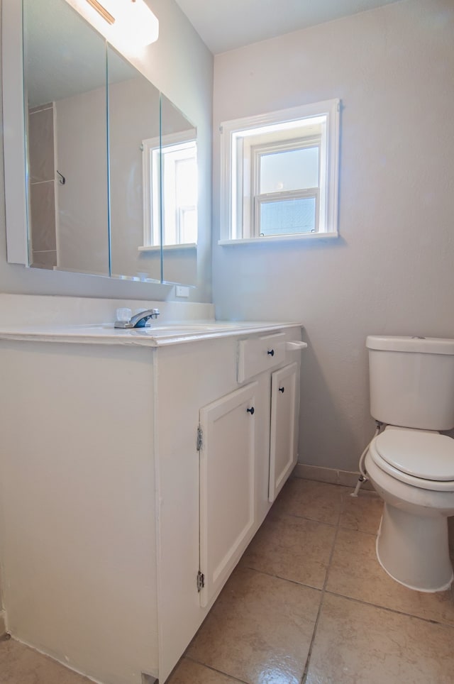 bathroom with vanity, tile patterned floors, toilet, and baseboards