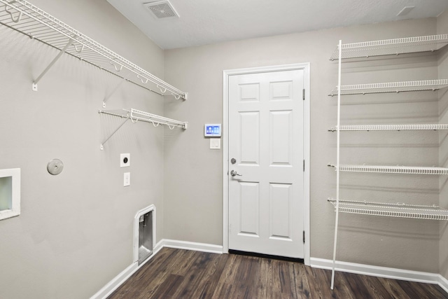 clothes washing area with electric dryer hookup, dark hardwood / wood-style floors, and hookup for a gas dryer