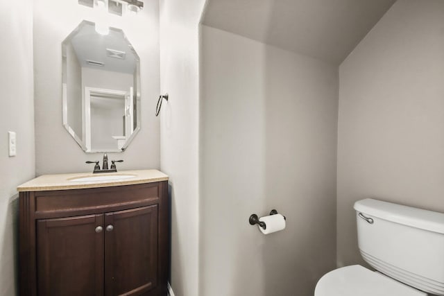 bathroom featuring toilet and vanity