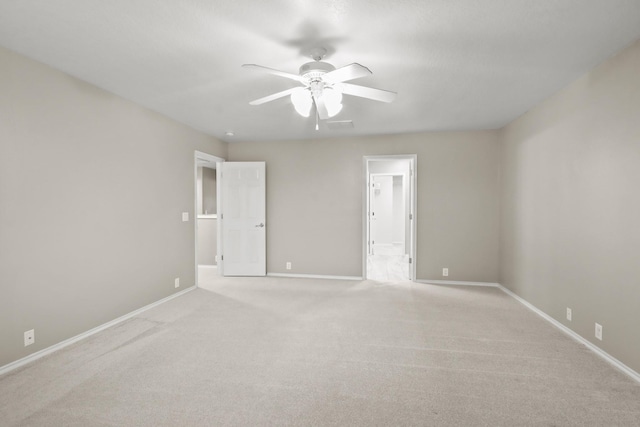 carpeted spare room with ceiling fan