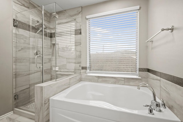 bathroom with shower with separate bathtub