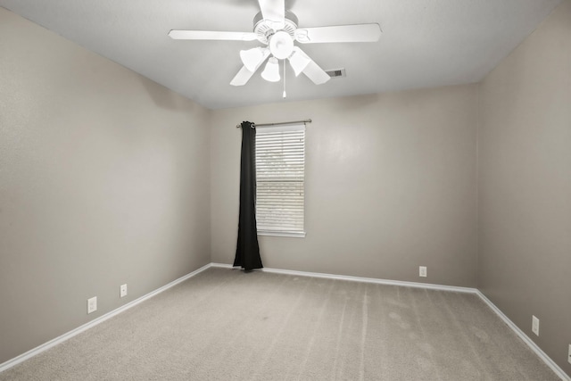 carpeted empty room featuring ceiling fan