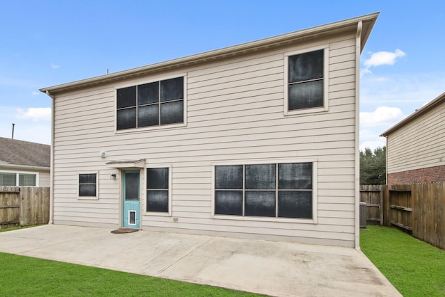 rear view of house with a patio area and a yard