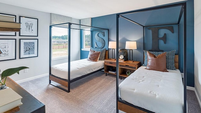 carpeted bedroom featuring baseboards