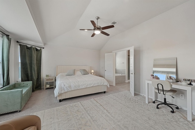 bedroom with ceiling fan, lofted ceiling, connected bathroom, and light colored carpet