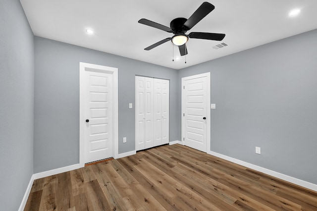 unfurnished bedroom featuring ceiling fan and hardwood / wood-style floors