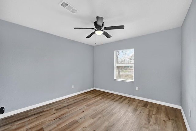 unfurnished room featuring ceiling fan and hardwood / wood-style flooring