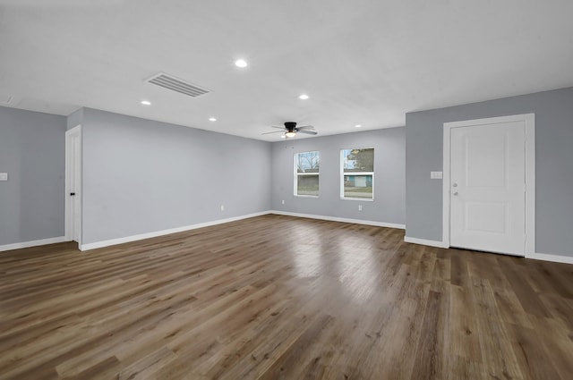 spare room featuring dark wood-type flooring and ceiling fan