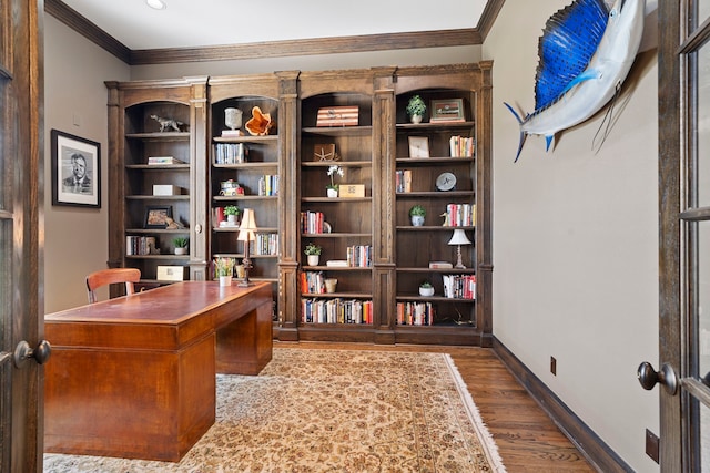 office space with dark wood-type flooring, ornamental molding, and french doors