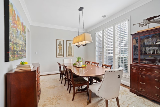 dining area featuring crown molding and a chandelier