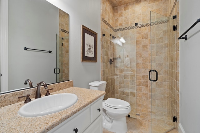 bathroom featuring a shower with shower door, toilet, and vanity